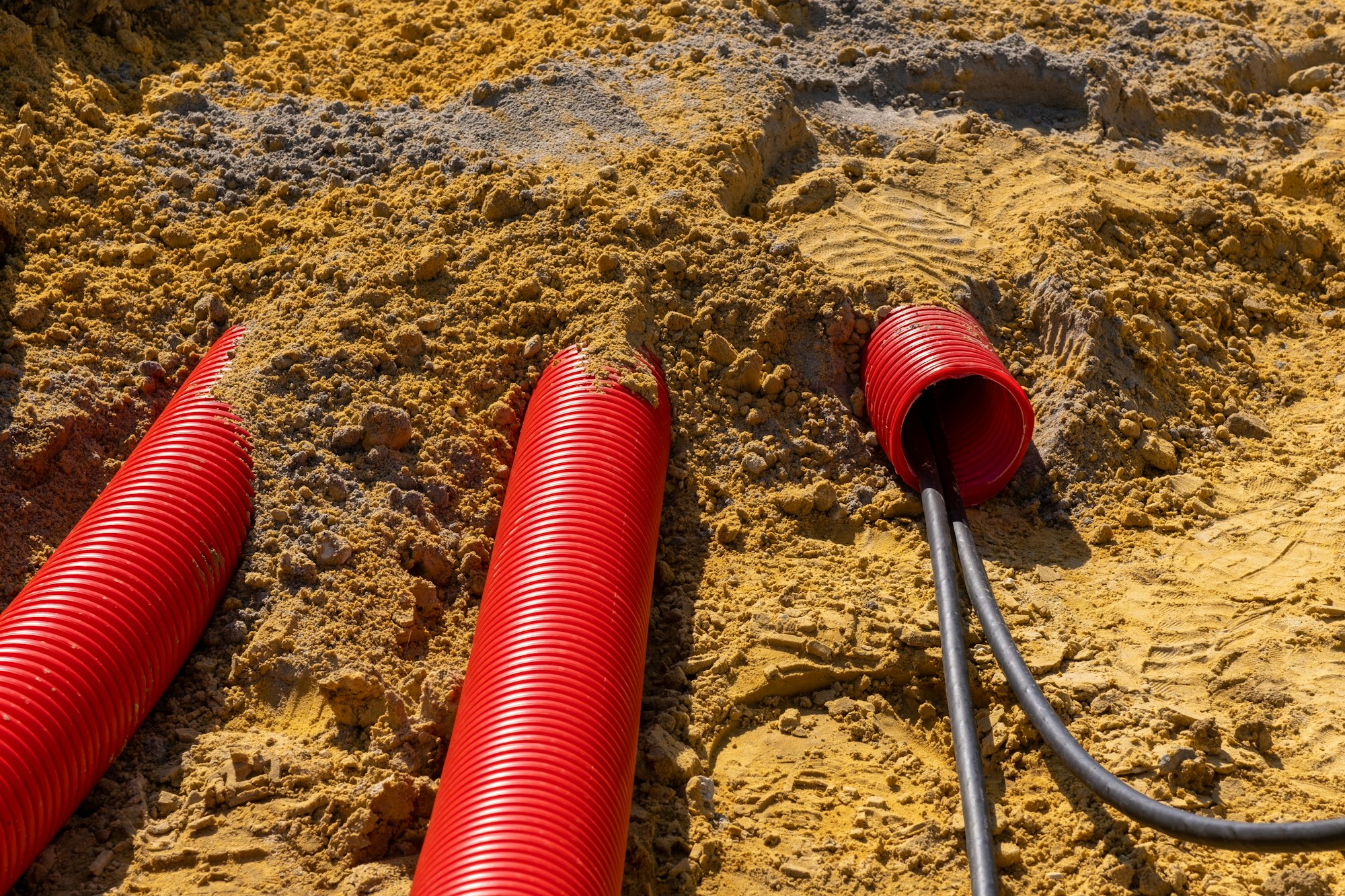 Red plumbing pipe close-up. Drainage tubing pipes. Red pipes of the water supply and heating system.